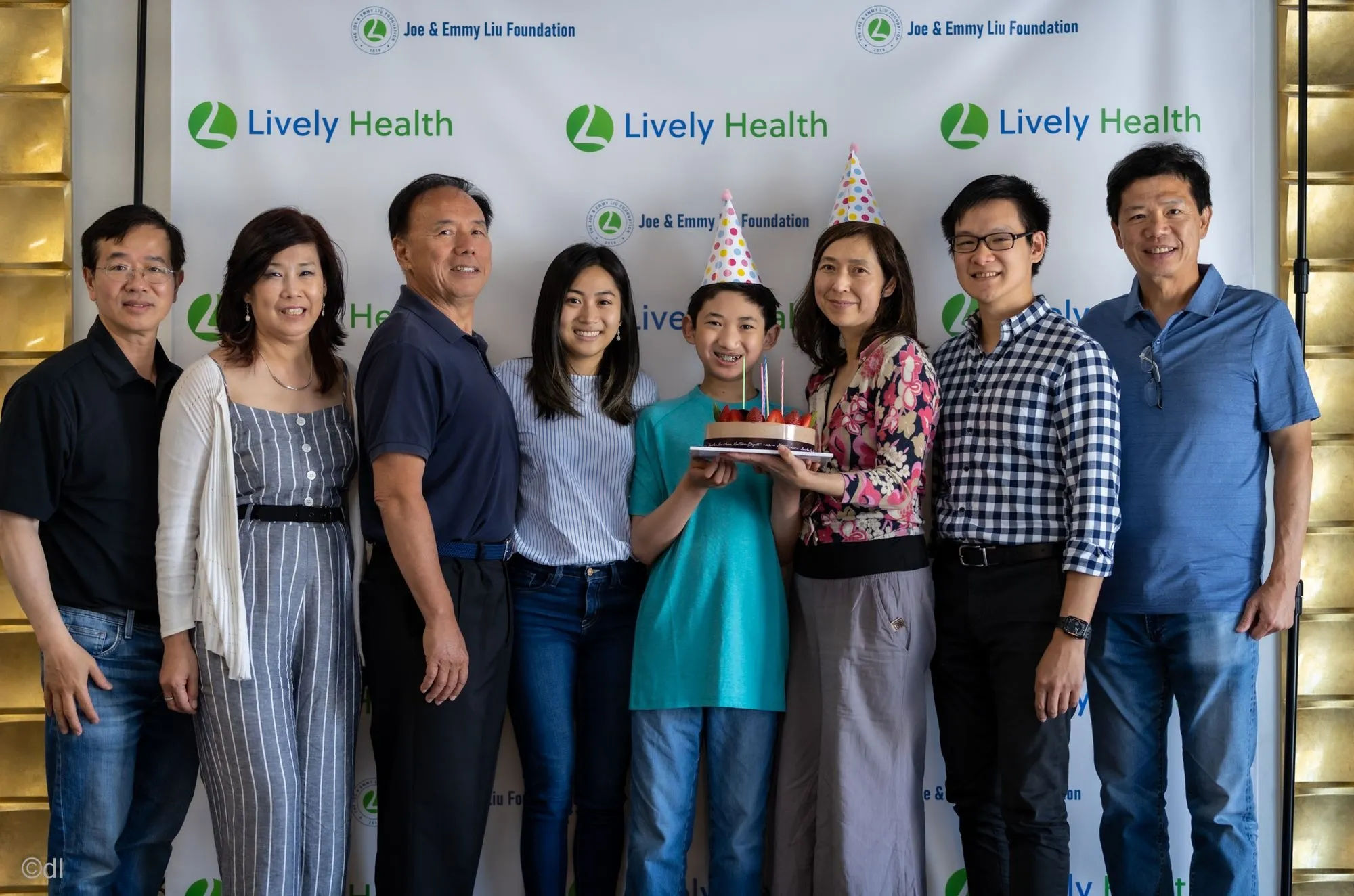 Foundation team members posing in front of a photo backdrop