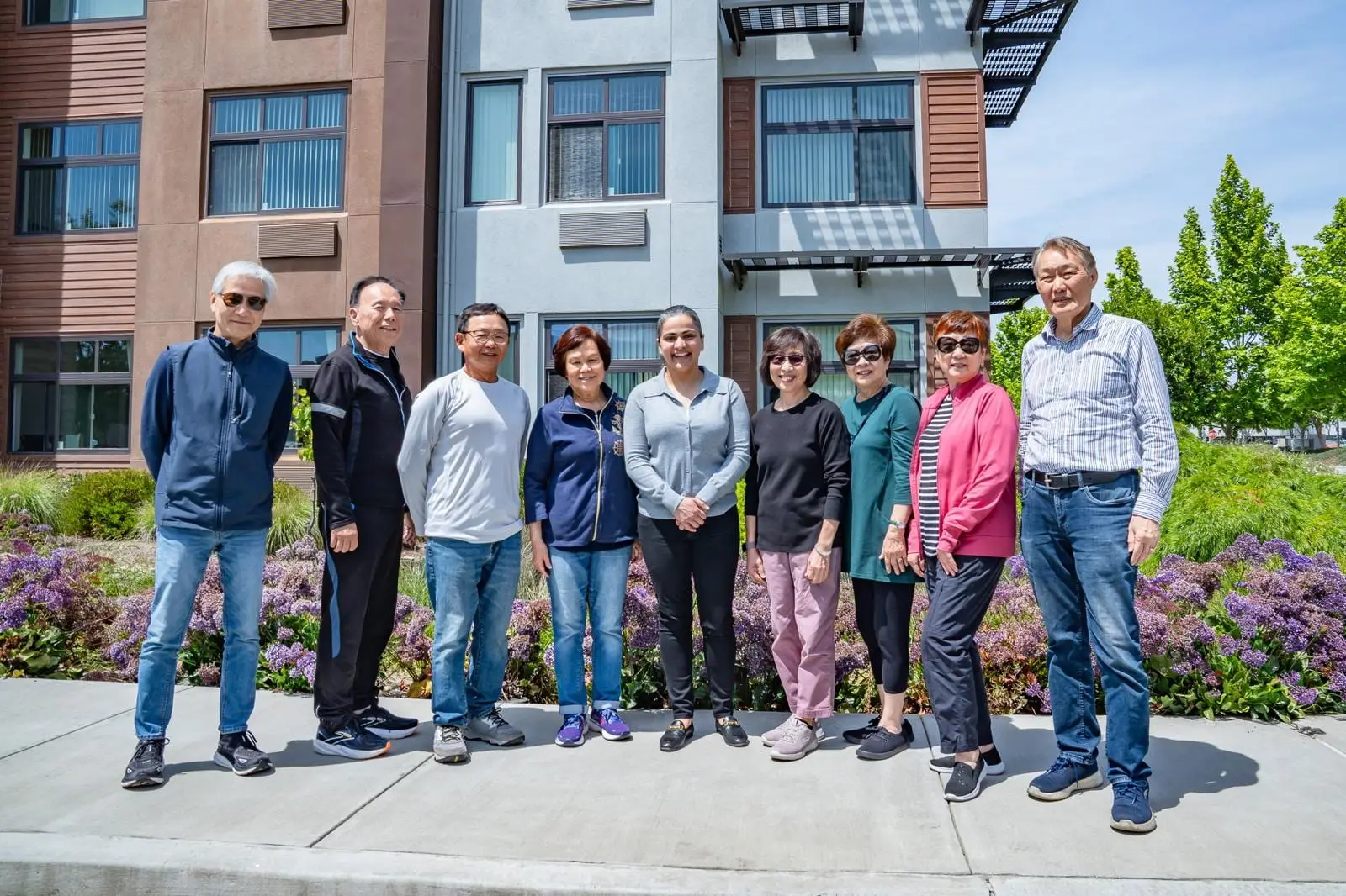 A group of Foundation supporters standing together outside an apartment complex