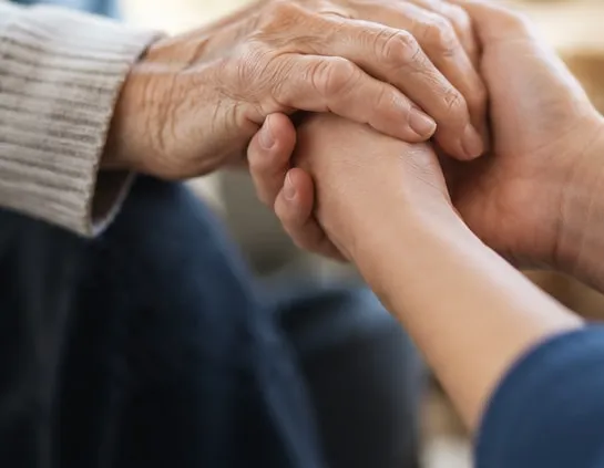 Two people holding hands