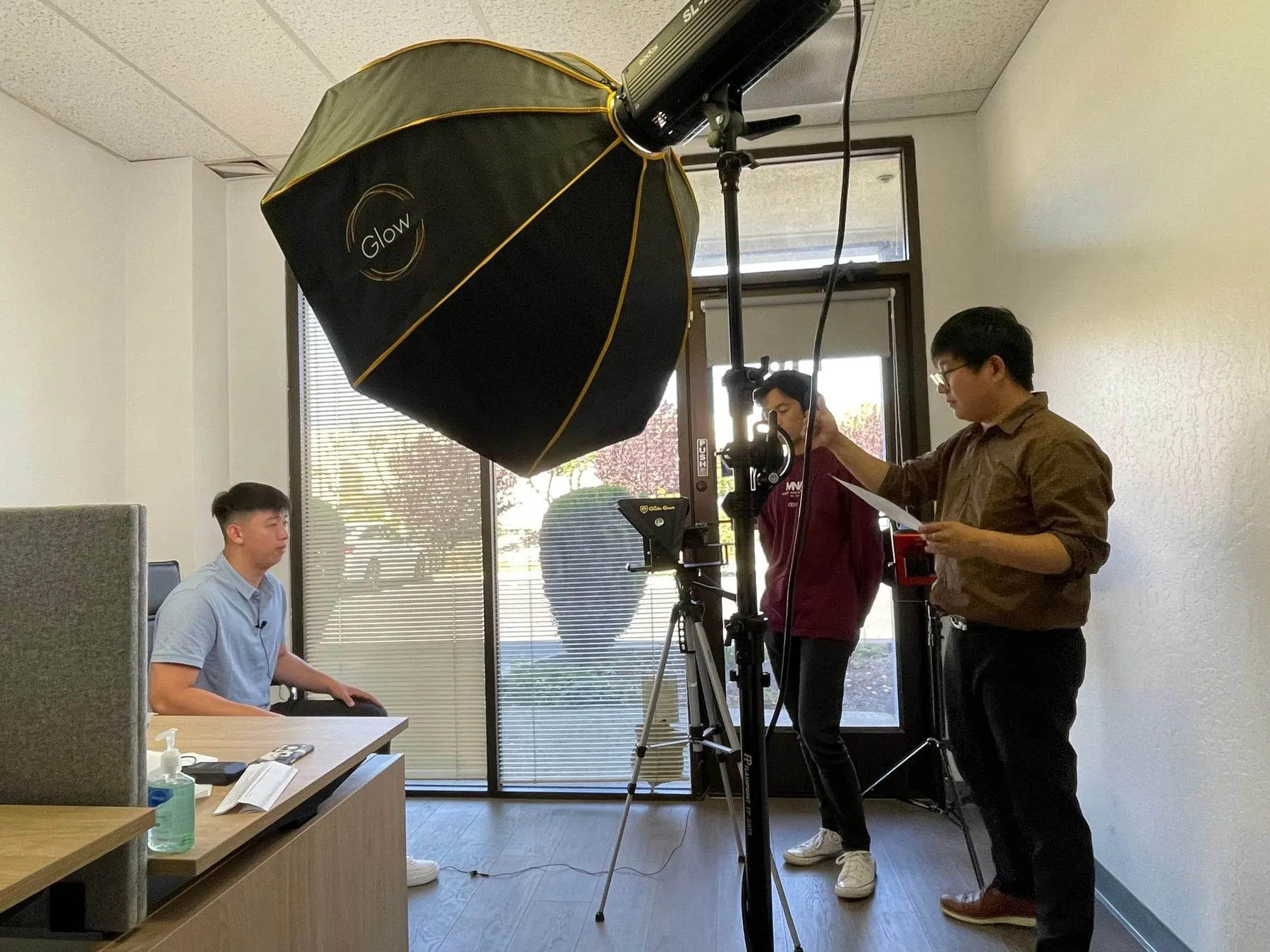 A Foundation video shoot with studio lighting and a crew at work