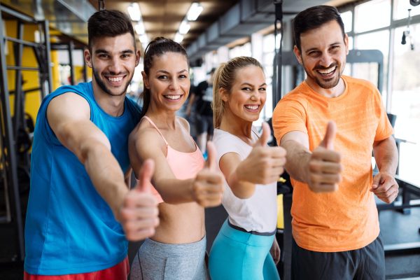 fitness, sport, exercising and healthy lifestyle concept - group of happy people in gym
